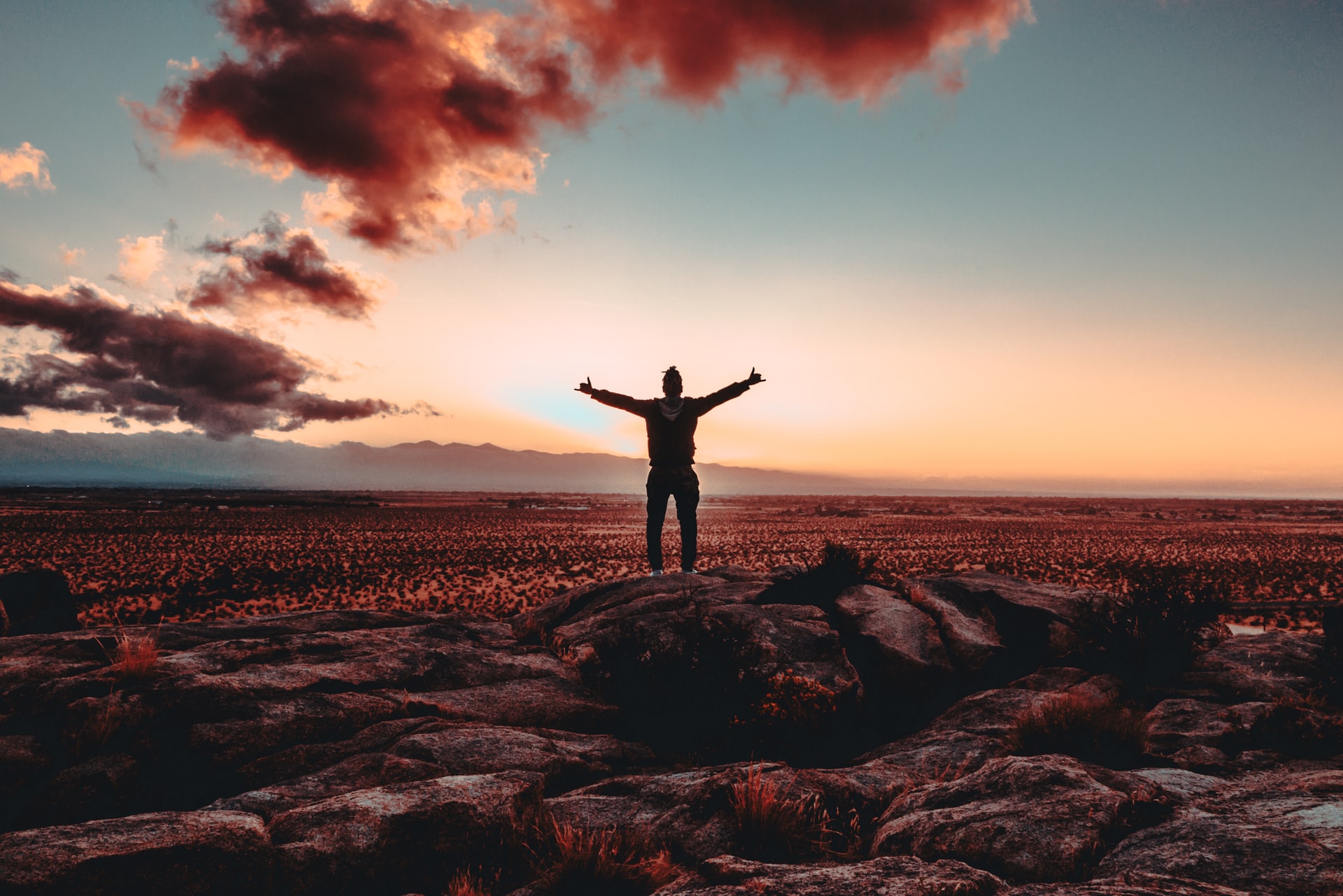 Man standing with his arms stretched wide